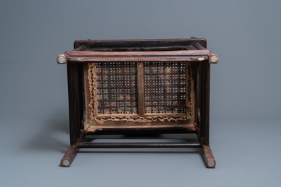 A pair of Chinese carved wooden chairs with wicker seats, 19th C.