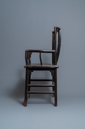 A pair of Chinese carved wooden chairs with wicker seats, 19th C.