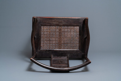 A pair of Chinese carved wooden chairs with wicker seats, 19th C.