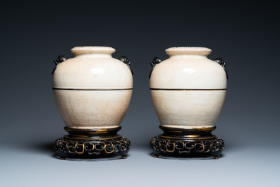A pair of Chinese monochrome Nanking crackle-glazed vases on reticulated bronze stands, 19th C.