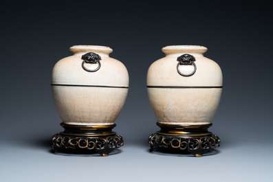 A pair of Chinese monochrome Nanking crackle-glazed vases on reticulated bronze stands, 19th C.