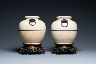 A pair of Chinese monochrome Nanking crackle-glazed vases on reticulated bronze stands, 19th C.