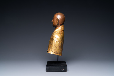 A Tibetan partly gilded brass bust of a Buddhist monk, 18th C.