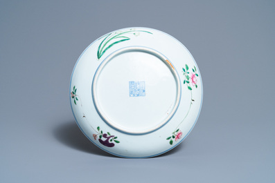 A Chinese famille rose dish with a boy, a hen and rooster and their chicks, Qianlong minyao mark and of the period