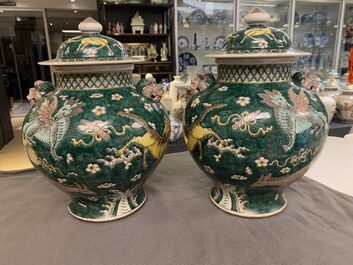 A pair of Chinese famille verte 'mythical animals' vases and covers, 19th C.