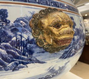 A large Chinese blue and white fish bowl with landscape design, Qianlong