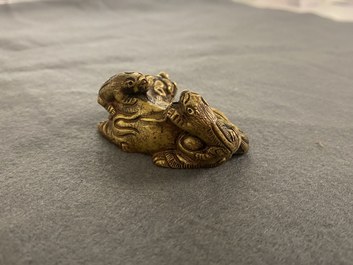 A Chinese gilt bronze 'lion with cubs' scroll weight, Qing