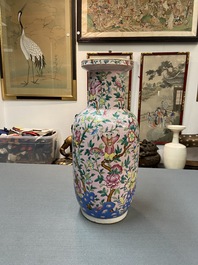 A Chinese pink-ground famille rose rouleau vase, 19th C.