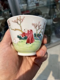 A Chinese famille rose cup and saucer with ladies and a boy playing with a rabbit, Yongzheng