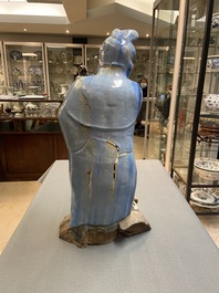 A large Chinese blue-glazed Shiwan pottery 'immortal' figure, 19th C.