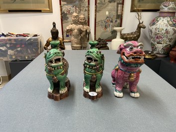 A Chinese famille rose model of a Buddhist lion and a pair of verte biscuit joss stick holders, 19th C.