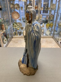 A large Chinese blue-glazed Shiwan pottery 'immortal' figure, 19th C.