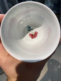 A Chinese famille rose cup and saucer with ladies and a boy playing with a rabbit, Yongzheng