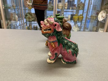 A Chinese famille rose model of a Buddhist lion and a pair of verte biscuit joss stick holders, 19th C.