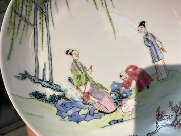 A Chinese famille rose cup and saucer with ladies and a boy playing with a rabbit, Yongzheng