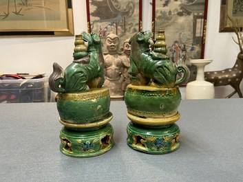 A pair of Chinese sancai-glazed biscuit Buddhist lion joss stick holders, Ming