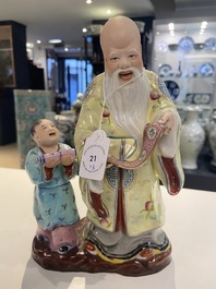 Two Chinese Yixing stoneware teapots and a famille rose 'Shou Lao' group, Kangxi and 20th C.