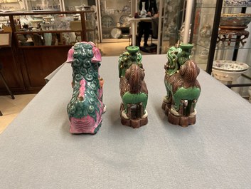 A Chinese famille rose model of a Buddhist lion and a pair of verte biscuit joss stick holders, 19th C.