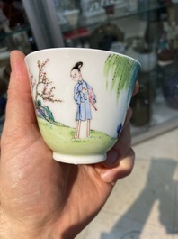 A Chinese famille rose cup and saucer with ladies and a boy playing with a rabbit, Yongzheng