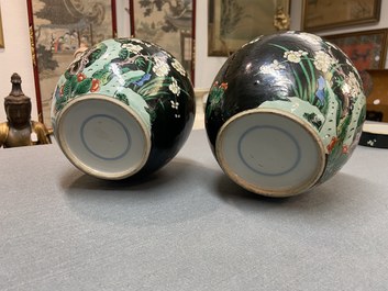 A pair of Chinese famille noire jars and covers, 19th C.