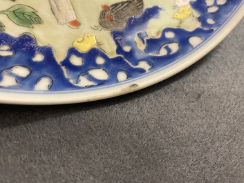 A Chinese famille rose dish with a boy, a hen and rooster and their chicks, Qianlong minyao mark and of the period