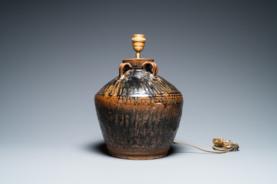 Een Chinese hengselpot met bruingevlekt zwart glazuur tot lamp omgevormd, Song