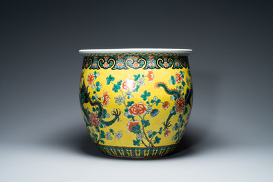 A Chinese yellow-ground famille verte 'dragons' fish bowl on gilded wooden stand, 19th C.