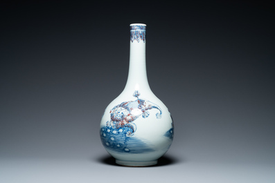 A Chinese blue, white and copper-red bottle vase with Buddhist lions, 20th C.