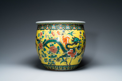 A Chinese yellow-ground famille verte 'dragons' fish bowl on gilded wooden stand, 19th C.