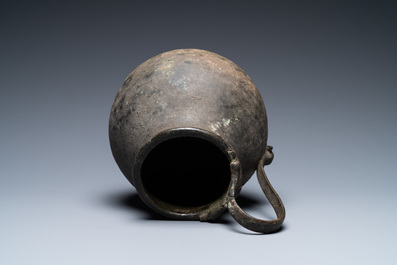 A Roman bronze ewer with a ram's head on the handle's low end, 2nd/3rd C.