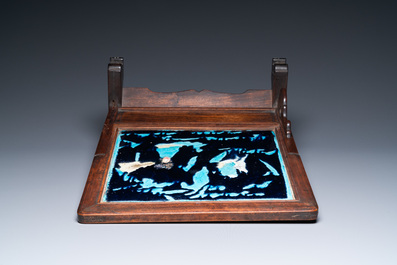 A Chinese square fahua plaque mounted in a wooden table screen, Ming