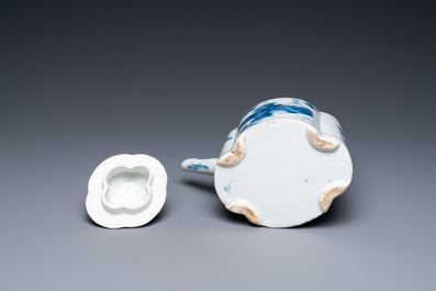 A Chinese blue and white arch-handled teapot and cover, Kangxi
