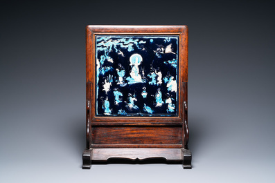 A Chinese square fahua plaque mounted in a wooden table screen, Ming