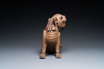A Chinese Yixing stoneware dog on wooden stand, 19th C