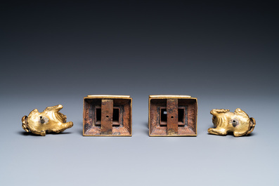 A pair of Chinese gilt bronze Buddhist lions on champlev&eacute; enamel bases, 18/19th C.