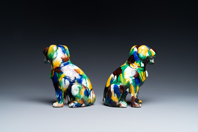A pair of Chinese sancai-glazed dogs on wooden stands, 19th C.