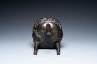 A Chinese bronze tripod censer with 'taotie' masks, Ming