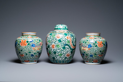 A pair of Chinese 'Buddhist lions' wucai vases and a covered 'phoenix' jar, 19th C.