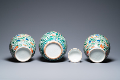 A pair of Chinese 'Buddhist lions' wucai vases and a covered 'phoenix' jar, 19th C.