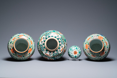 A pair of Chinese 'Buddhist lions' wucai vases and a covered 'phoenix' jar, 19th C.