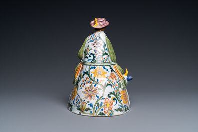 A polychrome Dutch Delft table bell in the shape of a lady on a cow, 18th C.