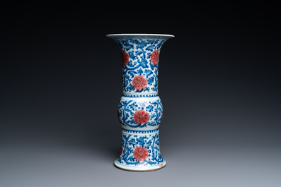 A Chinese blue, white and copper-red 'gu' vase with lotus scrolls, Kangxi