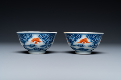 A pair of Chinese blue, white and iron-red cups and a yellow-ground 'dragon' dish, Guangxu mark and of the period