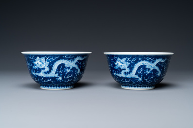 A pair of Chinese blue and white 'dragon' bowls, Kangxi mark, 19/20th C.