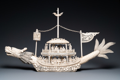 A Chinese carved ivory dragon boat on wooden stand, 19th C.