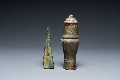 A Vietnamese bronze axe head, Dong Son, 3rd/1st C. BC and a small lime jar, L&ecirc; Dynasty, 15th C.