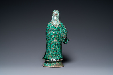 A Chinese verte biscuit figure of an immortal, 19th C.