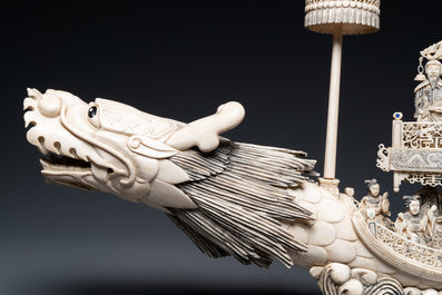 A Chinese carved ivory dragon boat on wooden stand, 19th C.