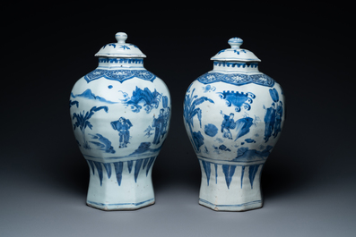 A pair of Chinese blue and white vases and covers with narrative design, Transitional period