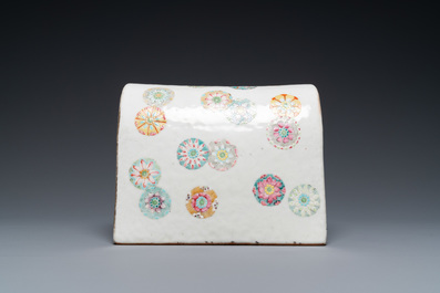 A Chinese famille rose neck pillow with floral balls, 19th C.